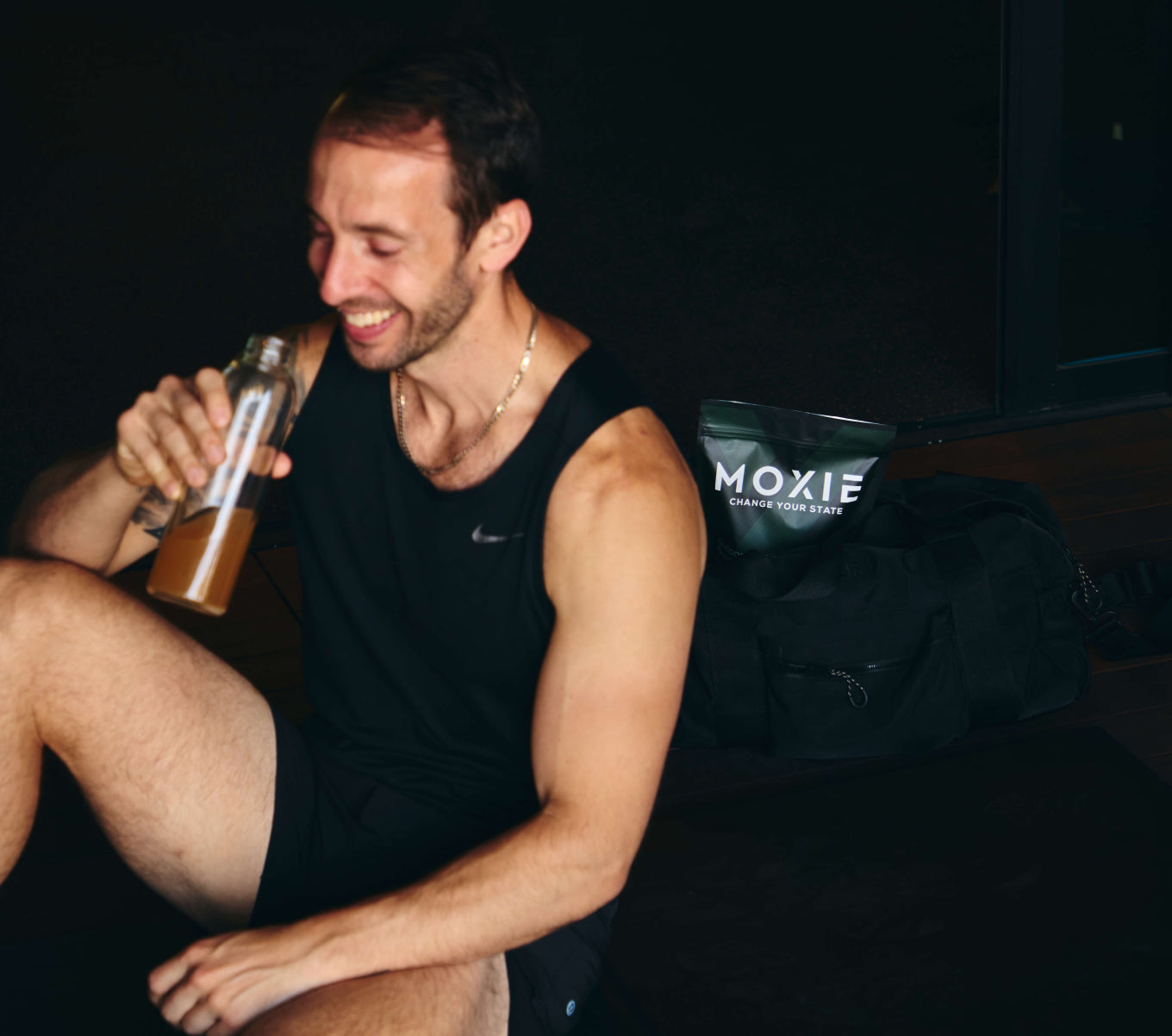 Photo of founder Ben Feinson drinking Moxie at the gym