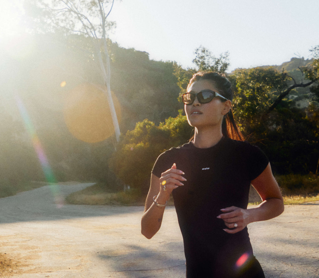 Photo of woman running outdoors in the sun